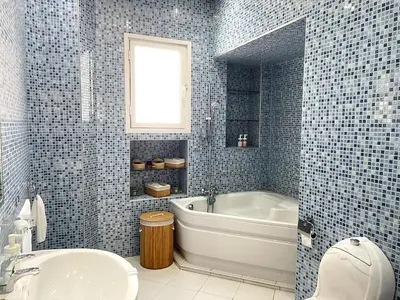 a blue tiled bathroom with a tub and a sink at Dar EL BAHIA - Spacious flat with large Terrace in Casablanca