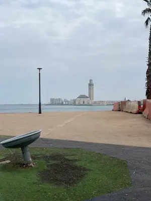 a bench sitting on the side of a beach at Appartement luxe in Casablanca