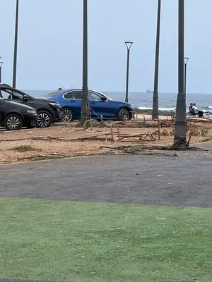 a group of cars parked next to the beach at Appartement luxe in Casablanca