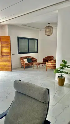 a living room with a couch and a table at Spacieuse villa oued cherrat bouznika in Bouznika