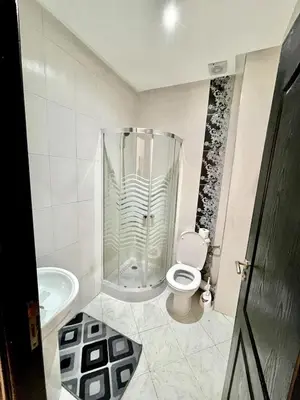 a bathroom with a shower with a toilet and a sink at Appartement à Sidi Rahal Piscine et Accès direct plage in Sidi Rahal
