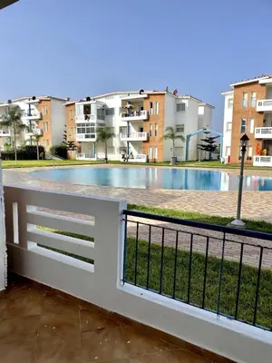 a view of the pool from the balcony of a apartment at Appartement à Sidi Rahal Piscine et Accès direct plage in Sidi Rahal