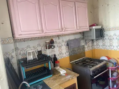 a small kitchen with pink cabinets and a stove at Comfort and Convenience in Casablanca