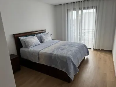 a bedroom with a bed and a large window at Blue dhalia beach a sidi rahal in Dar Oulad Hajj Kassem
