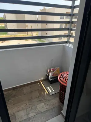 a balcony with a view of a window at Blue dhalia beach a sidi rahal in Dar Oulad Hajj Kassem