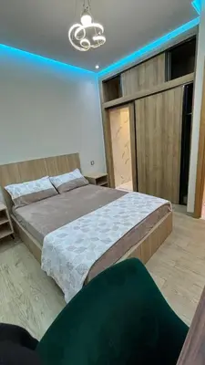 a bedroom with a large bed and a large window at Studio lux in Bouznika