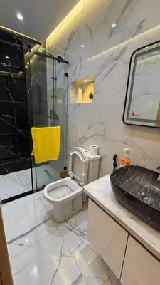 a bathroom with a shower and a toilet and a sink at Studio lux in Bouznika