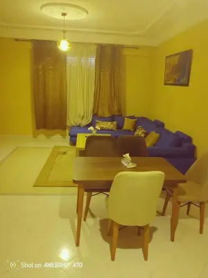 a living room with a purple couch and a table at Appartement Alhadika in Casablanca