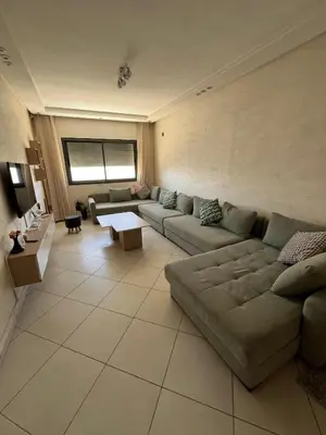 a large living room with a couch and a table at Dar laakbira in Bouznika