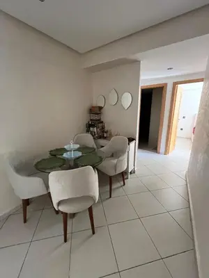 a dining room with a table and some chairs at Dar laakbira in Bouznika