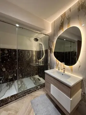 a bathroom with a shower and a sink and a mirror at Escape for the whole family in Casablanca