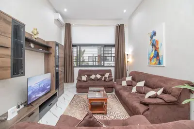 a living room with a couch and a tv at Les rochers in Casablanca