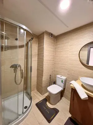 a bathroom with a shower and a toilet and a sink at Cozy Relax in Mohammedia