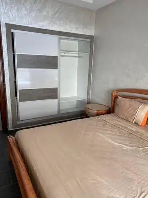 a bedroom with a bed and a large window at Cozy Relax in Mohammedia