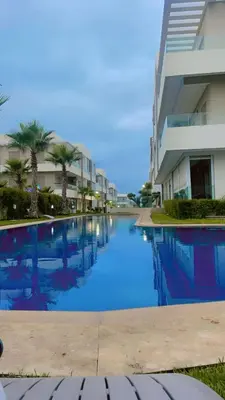 a large swimming pool in front of a building at Heaven Beach Sidi Rahal in Sidi Rahal
