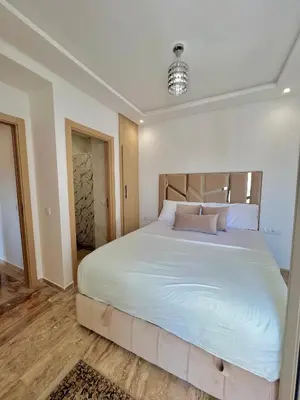 a bedroom with a large bed with white sheets and pillows at Heaven Beach Sidi Rahal in Sidi Rahal