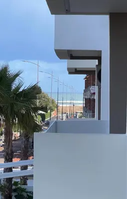 a view of a street from a building with a palm tree at Heaven Beach Sidi Rahal in Sidi Rahal