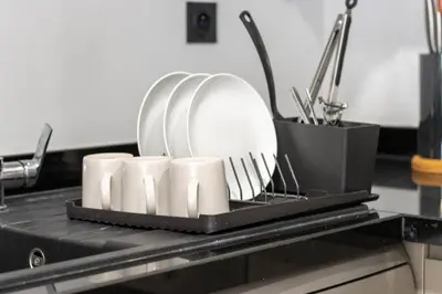 a tray with plates and cups on a kitchen counter at BRYJ 34 Luxury studio les princesses maarif in Casablanca