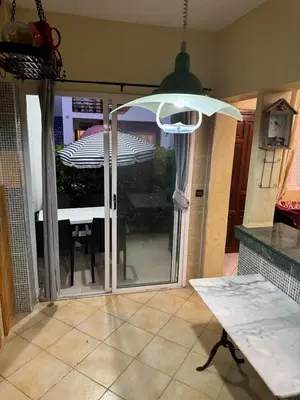 an open door to a patio with an umbrella at Modern appartment in Casablanca