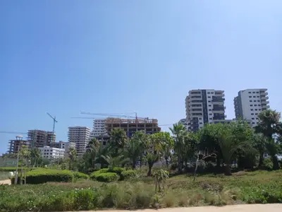 a city skyline with palm trees and buildings at Cozy Studio Vue sur Piscine à Ocean Park Zenata City Eco in Aïn Harrouda