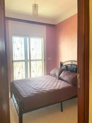 a bedroom with a bed with purple walls and a window at Ocean View Villa avec Piscine en Bord de Mer in Sidi Rahal