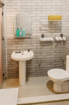 a bathroom with a white sink and a toilet at Traditional Moroccan Apartment, Oulfa, Hajj Fateh in Casablanca