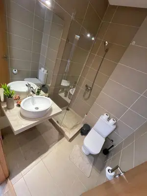a bathroom with a shower and a toilet and a sink at Villa a darbouaza in Dar Bouazza
