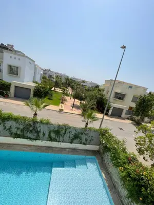a swimming pool in front of a building at Villa a darbouaza in Dar Bouazza