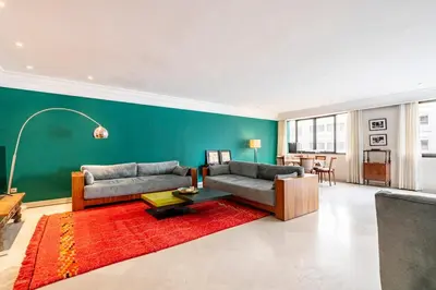a living room with two couches and a red rug at Chic appartement in Casablanca in Casablanca