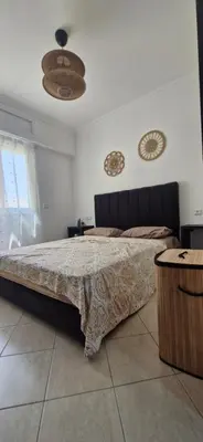 a bedroom with a large bed in a room at Séjour Idéal Piscine & Sécurité in Bouznika