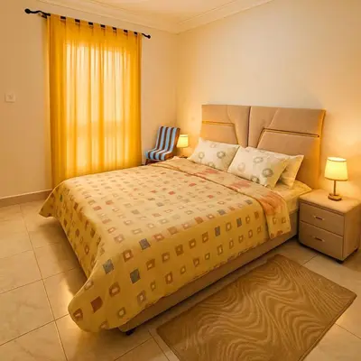 a bedroom with a large bed and a window at Résidence calme 3 chambres pour votre hébergement in Bouznika