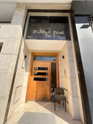 a door to a building with a chair in front at cozy furnished studio fully equipped in Casablanca