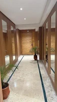 a hallway with two potted plants in a building at Flat in Sidi Rahal Chatai with Ocean View in Sidi Rahal