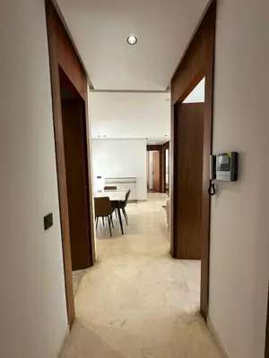 a hallway with a table and chairs in a room at appartement les princesses 2chmbr salon 2 terasse in Maarif