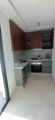 a kitchen with a sink and a stove at appartement les princesses 2chmbr salon 2 terasse in Maarif