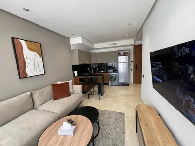 a living room with a couch and a table at Modern Studio Princesses District in Maarif