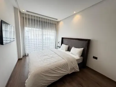 a bedroom with a large bed and a large window at Élégant Studio Neuf Quartier 2 Mars Sécurisé in Aïn Chock