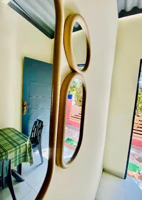 a mirror in a room with a table and a chair at Plage à Pied Refuge Relaxant Design Moderne in Tamaris