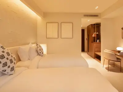 a hotel room with two beds and a table at STORY Le Carrousel Rabat in Rabat