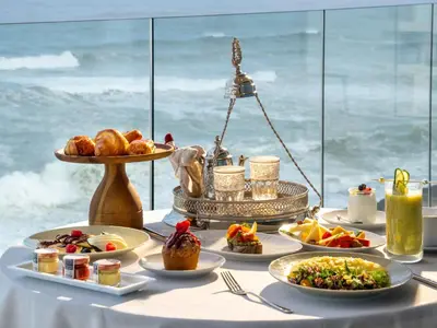 a table with food on it with a view of the ocean at STORY Le Carrousel Rabat in Rabat