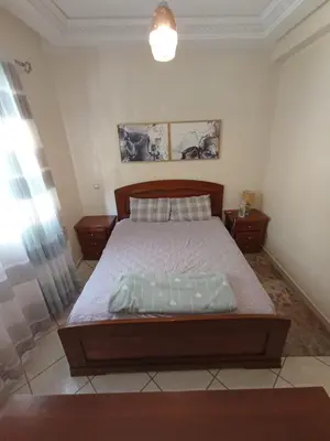 a bedroom with a large bed in a room at SUMMER AND FAMILY APPARTEMMENT ,mouhamadia in Mohammedia