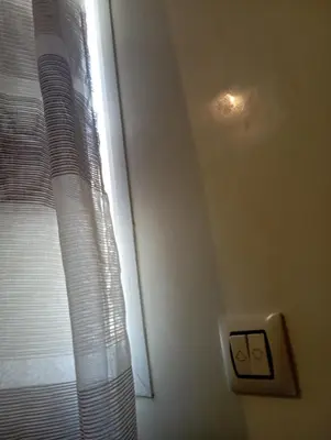 a window with a white curtain and a light at SUMMER AND FAMILY APPARTEMMENT ,mouhamadia in Mohammedia
