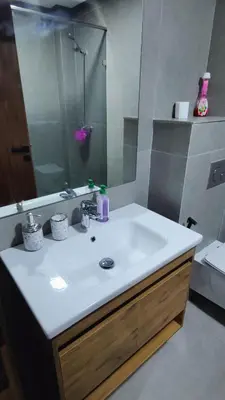 a bathroom with a sink and a mirror at Appartement de prestige à Dar bouazza avec plusieurs piscines et à proximité à la plage in Tamaris