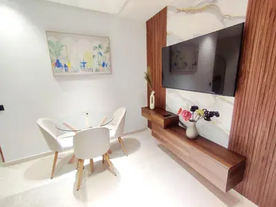 a dining room with a table and a tv at Studio Confortable et Cozy 5 min du stade CAN2025- Maarif Casablanca in Casablanca