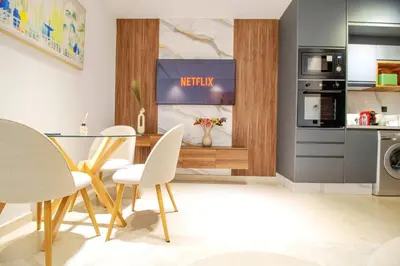 a kitchen and dining room with a table and chairs at Studio Confortable et Cozy 5 min du stade CAN2025- Maarif Casablanca in Casablanca