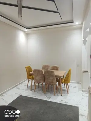 a dining room with a table and chairs at Appart Bouznika neuf in Bouznika