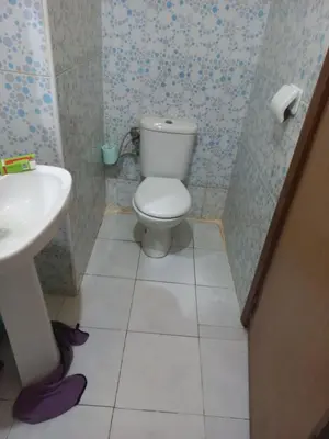 a bathroom with a toilet and a sink at رياض اللويزية in Mohammedia