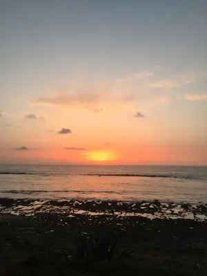 a sunset on the beach with the ocean at Dar Alyakoute - Harhoura in Temara