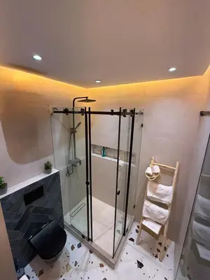 a shower with a glass door in a bathroom at New apartment in the heart of Rabat in Rabat