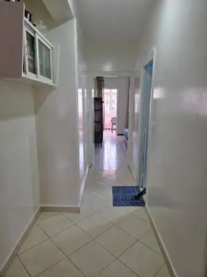 a room with a hallway with white walls and a door at SUNSET Room in Rabat